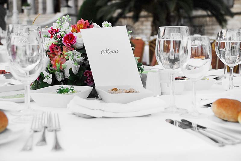 Stylish menu on a dinner table with food